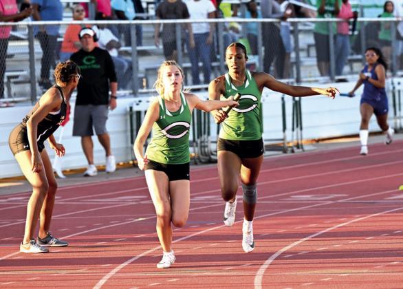 Emeree Dasilva makes a clean hand off to Madyx Blain, with the 4x200M relay winning 1st place.