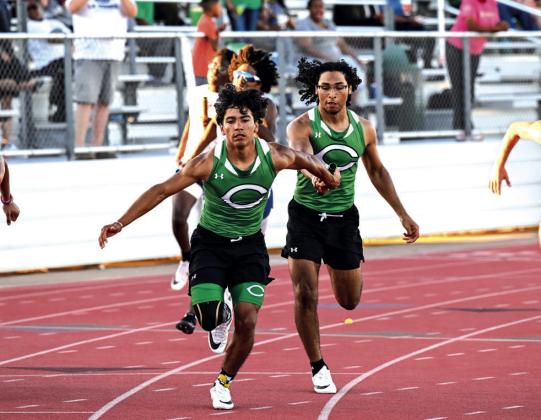 Day'ton Varela hands off the baton to Brayden Hernandez in the 4x200M relay, with the team advancing to area.